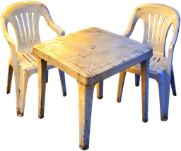 A small plastic table with two white plastic chairs, as at a Lagos roadside stall